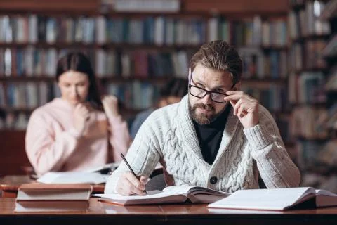 Confident man taking notes at public library Foto stock