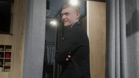 Confident Man Trying on Suit in Fitting Room Stock Footage 330514837