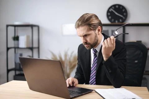 Confident man using computer at workplace Stock Photos