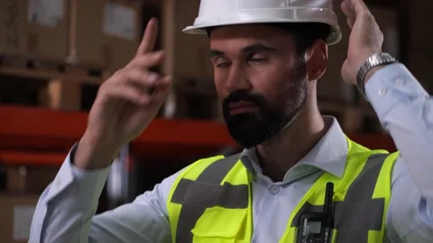 Confident man warehouse worker putting on hard hat Stock Footage 161947847