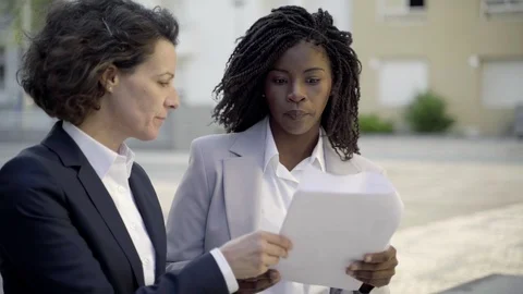 Confident managers discussing documents on street Video stock 114011873