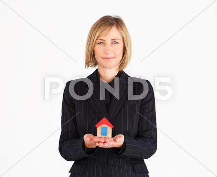 Confident mature businesswoman holding a house Stock-Fotos