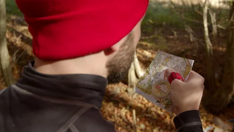 Confident mid adult looking into map for directions. Puts his hand down. Autumn Stock Footage 166155256