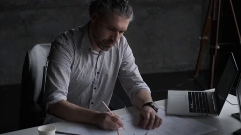 Confident middle-aged man working sitting at the table in the office. Stock Footage 107329366