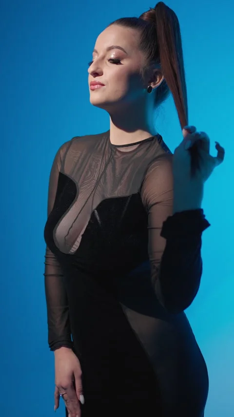 Confident model with original hairstyle. Model in evening dress holds her long Stock Footage 276176159