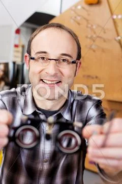Confident optician holding test lenses Stock Photos