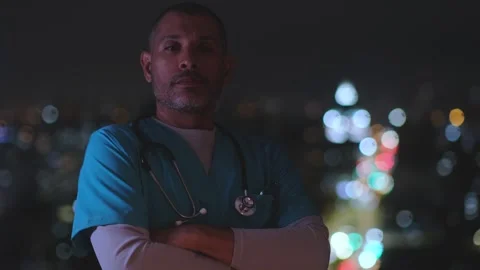 Confident paramedic posing at night with emergency lights Stock Footage 327541924