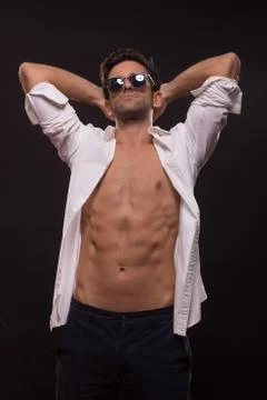 Confident posing young man abs fit slim unbuttoned shirt Stock Photos