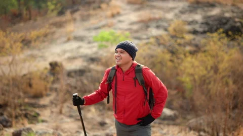 Confident powerful man with backpack hiking raises arms in the air. Stock Footage 171791883
