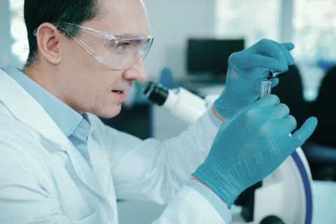Confident practitioner combining two liquids Foto stock