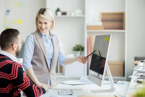 Confident pretty web designer presenting her project Stock Photos