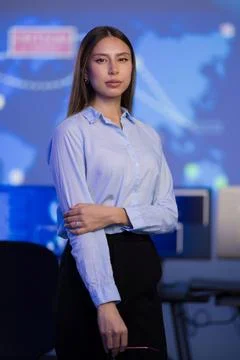 Confident professional in a command center with data visualizations on screen Stock Photos