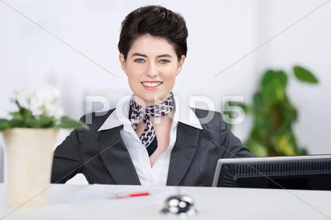 Confident receptionist smiling at counter Stock Photos
