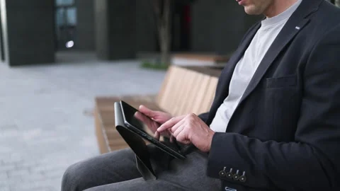Confident serious businessman using a digital tablet outside Stock Footage 340519094