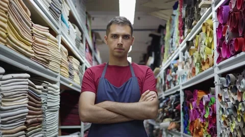Confident shoemaker posing in leather and textile storage Stock Footage 142549944