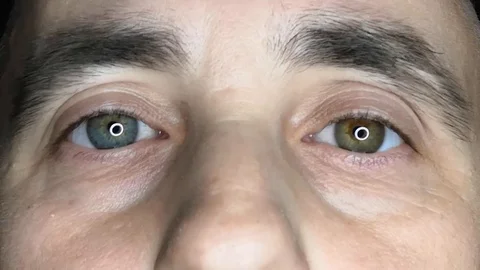 The confident, slightly sad look of an elderly man with multi-colored eyes. Stock Footage 130057392