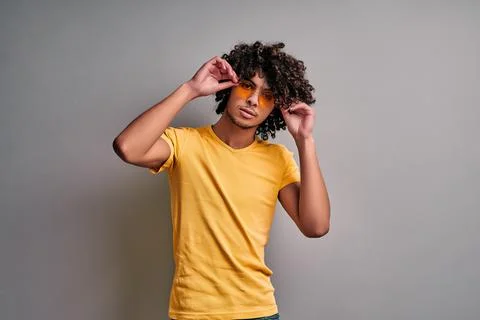 Confident smart eastern student on isolated gray background Stock Photos
