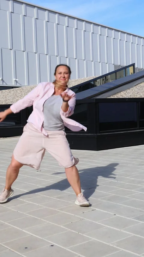 Confident Smiling Young Plus-Size Woman Dancing Outdoors in City, Joyful Curvy Stock Footage 301081265