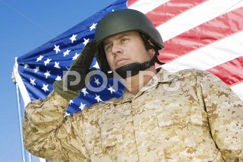 Confident Soldier Saluting In Front Of American Flag Stock Photos