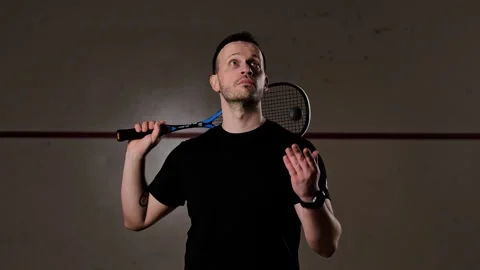 Confident Squash Player Tosses Ball in Dark Court Slow Motion Portrait Sequence Stock Footage 313477513