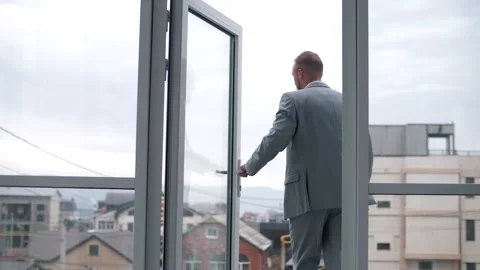 The confident steps manager leaves the office with panoramic windows Stock Footage 151647698