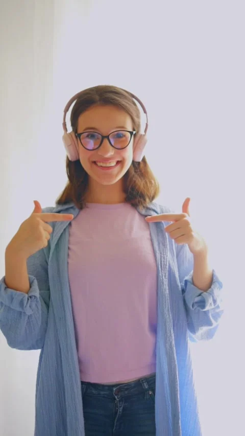 Confident student pointing at herself proudly on white background. Ideal for Stock Footage 312640331