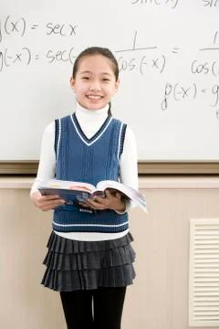 Confident student standing in front of math work Stock Photos