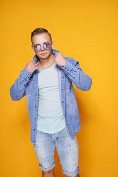 Confident stylish casual guy posing on yellow Stock Photos