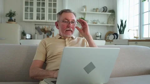 Confident stylish happy middle aged senior man using laptop at home. Stylish Stock Footage 244404422