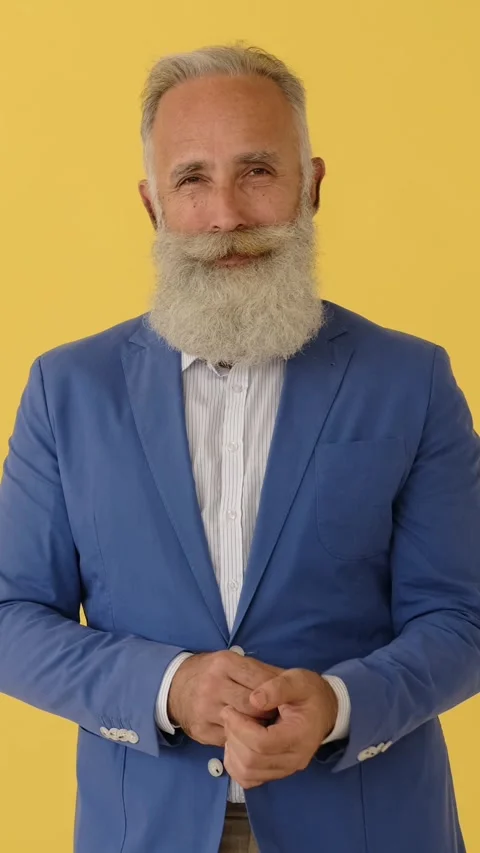 Confident stylish senior man with beard buttoning jacket 動画素材 321151678