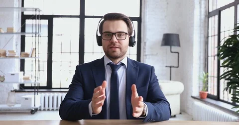 Confident support service representative wears headset talking to webcam Stock Footage 126604678