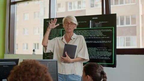 Confident Teacher Explaining Kids How to Work with Programming Languages Stock Footage 316482495