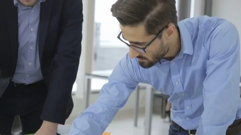 Confident team leader explaining his ideas to other employees Stock Footage 73993595