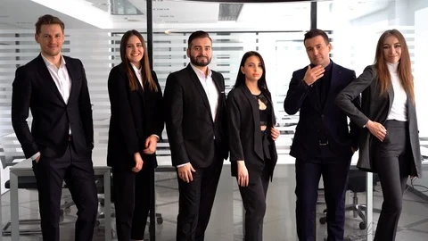 Confident team. Successful colleagues posing at camera Stock Footage 127414464