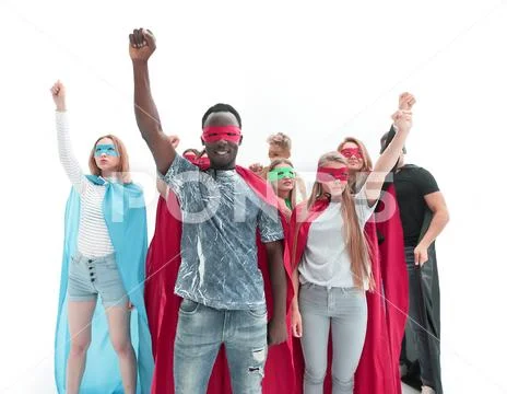 Confident team of superheroes standing in a bright office Stock Photos