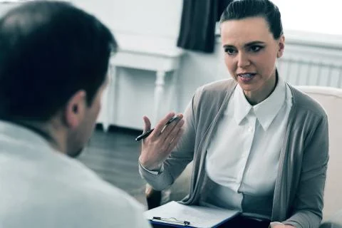 Confident therapist talking with her client Stock Photos