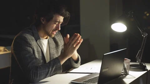 A confident but tired programmer works at a computer at night. The Desk Lamp Lit Stock-Footage 237911830