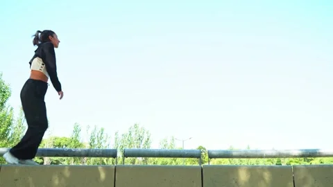 Confident urban dancer performing in a sunny park Video stock 303373869