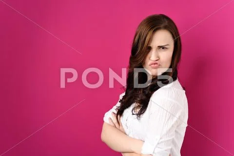 Confident Woman with Arms Crossed and Pouting Lips Stock Photos