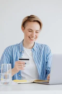 Confident woman with a laptop in the home office shopping online Stock Photos