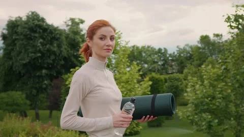 Confident woman looking to camera getting ready to intensive workout outdoor Stock Footage 296575018