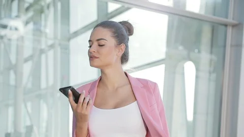 Confident Woman Using Loudspeaker while talking on her Mobile Phone Stock Footage 89916135