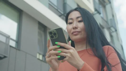 Confident Woman Using Smartphone While Walking In Modern City Street Video stock 318985757