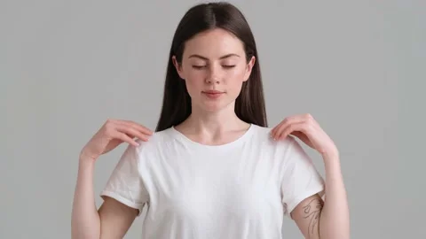 A confident woman wearing basic T-shirt is looking to the camera Video stock 154947426