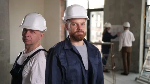 Confident workers posing in renovated apartment Stock Footage 149073870