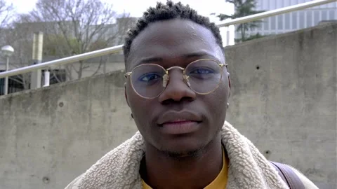 Confident young black man looking at camera with serious expression. 4k video Stock Footage 221249612
