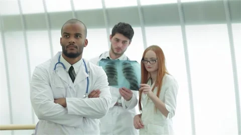 Confident young doctors analyzing x-ray of healthy lungs Stock Footage 311808438