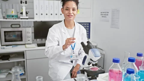 Confident young hispanic scientist, a beautiful woman with curly hair, smil.. Stock Footage 262203402