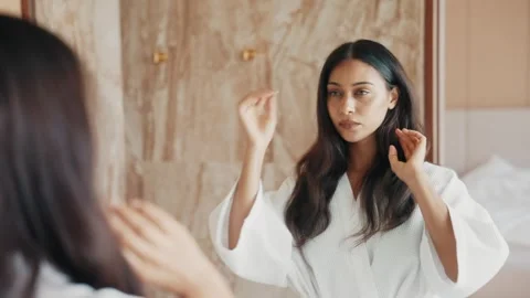 Confident Young Lady Touching Her Silky Hair In Front Of Bathroom Mirror Stock Footage 333223840