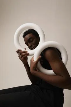 Confident young man looking at the camera keeping two circle. Vertical mock-up. Fotos de archivo